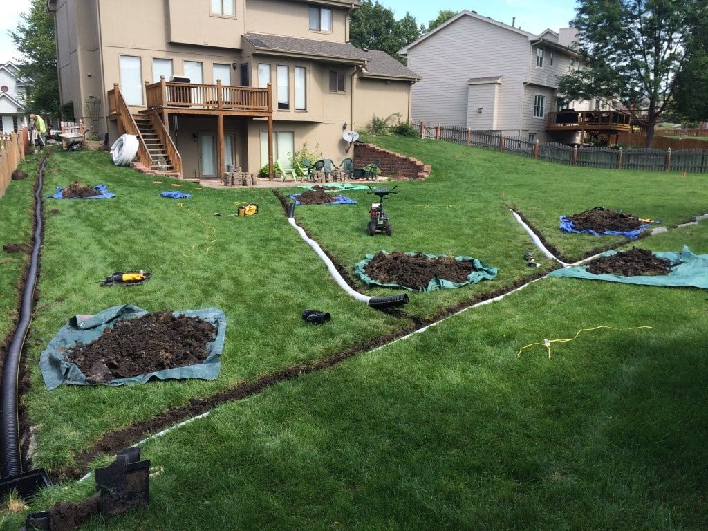 drainage pipes being installed in backyard