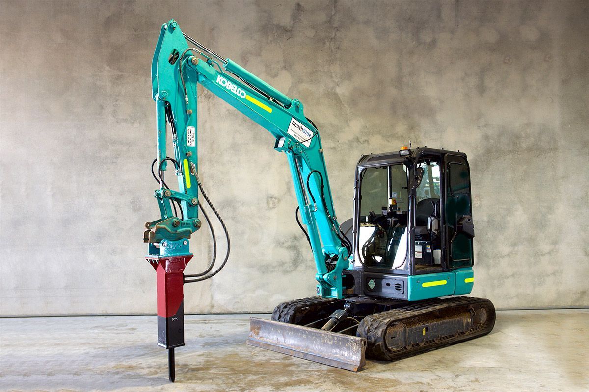A blue and black excavator with a red hammer attached to it.