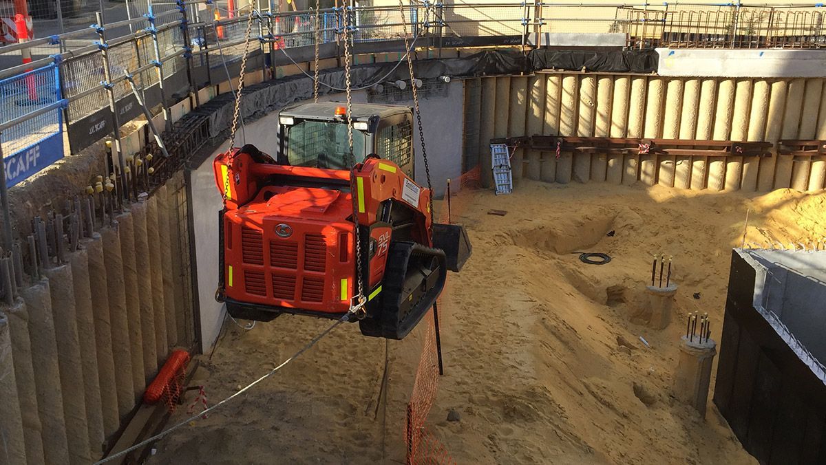 A construction site with a tractor in the middle of it.
