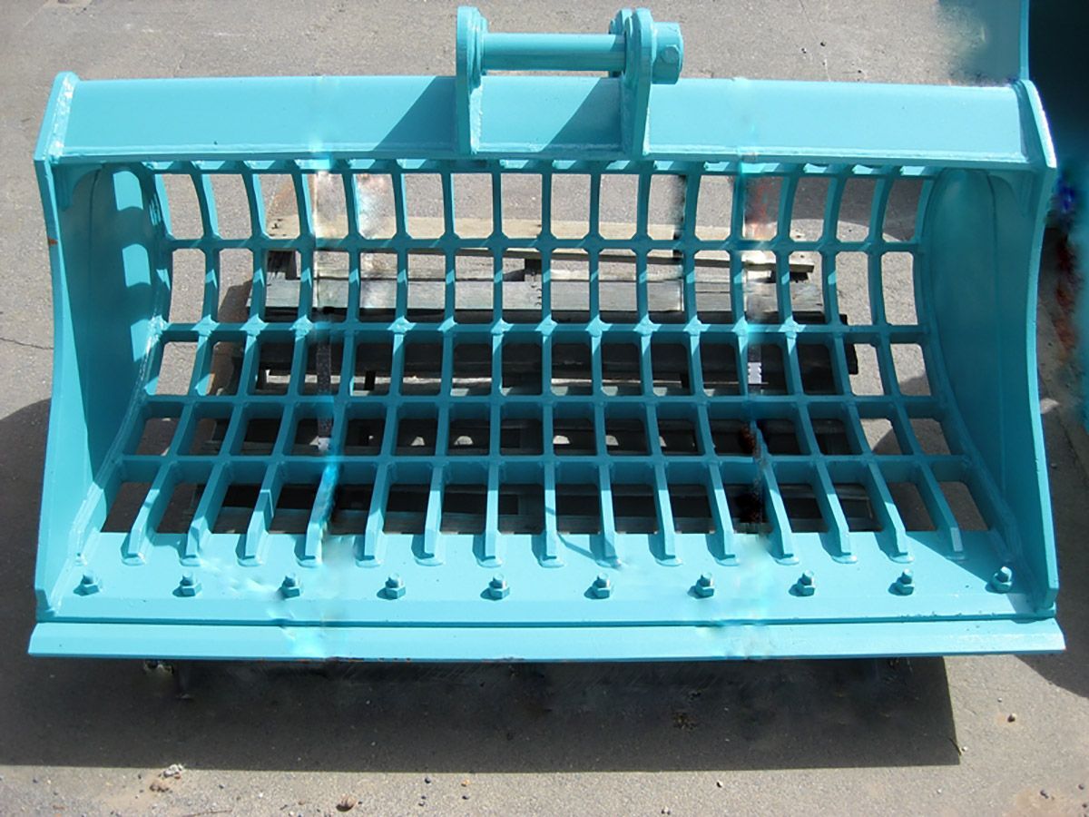 A blue bucket with holes in it is sitting on the ground