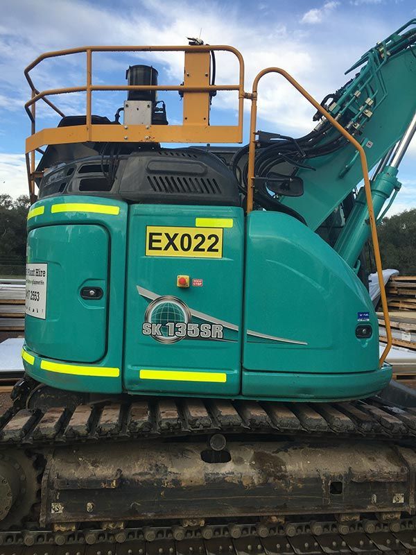 A blue excavator with the number ex022 on it