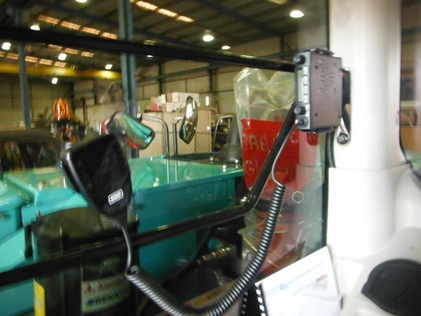A microphone is attached to the side of a vehicle in a warehouse.
