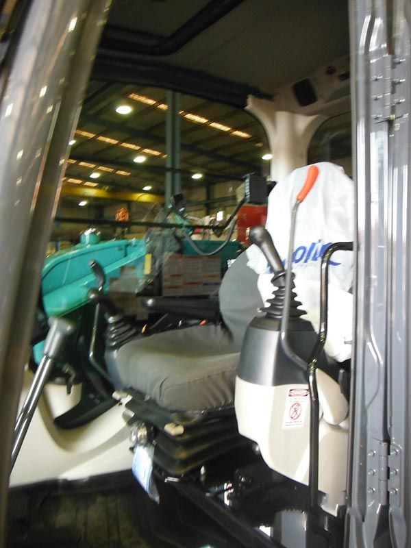 The inside of a vehicle with the word olmc on the seat