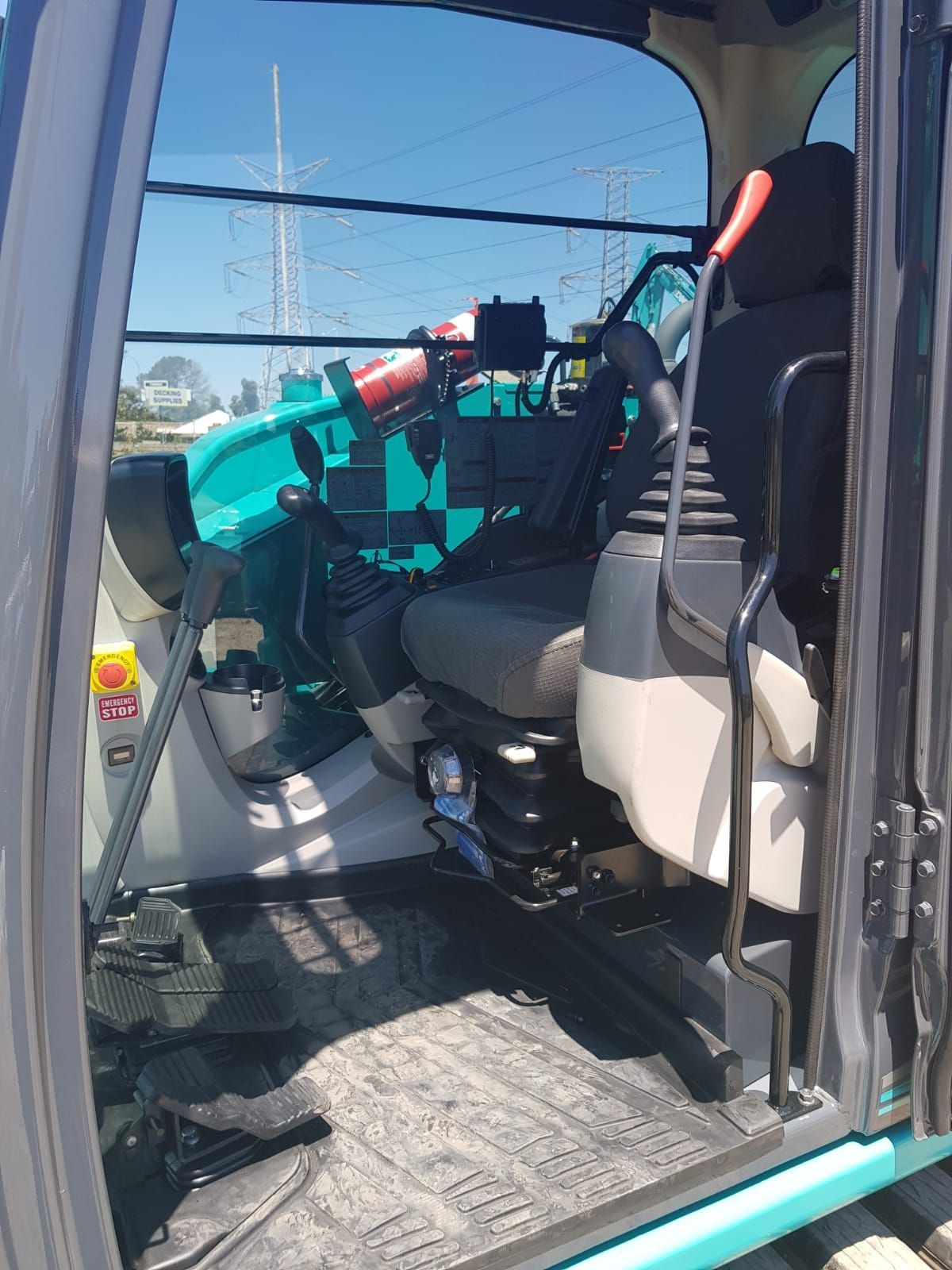 The inside of a construction vehicle with the door open.