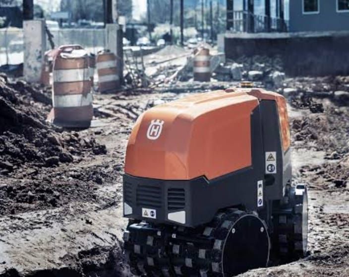 A husqvarna machine is driving through a construction site