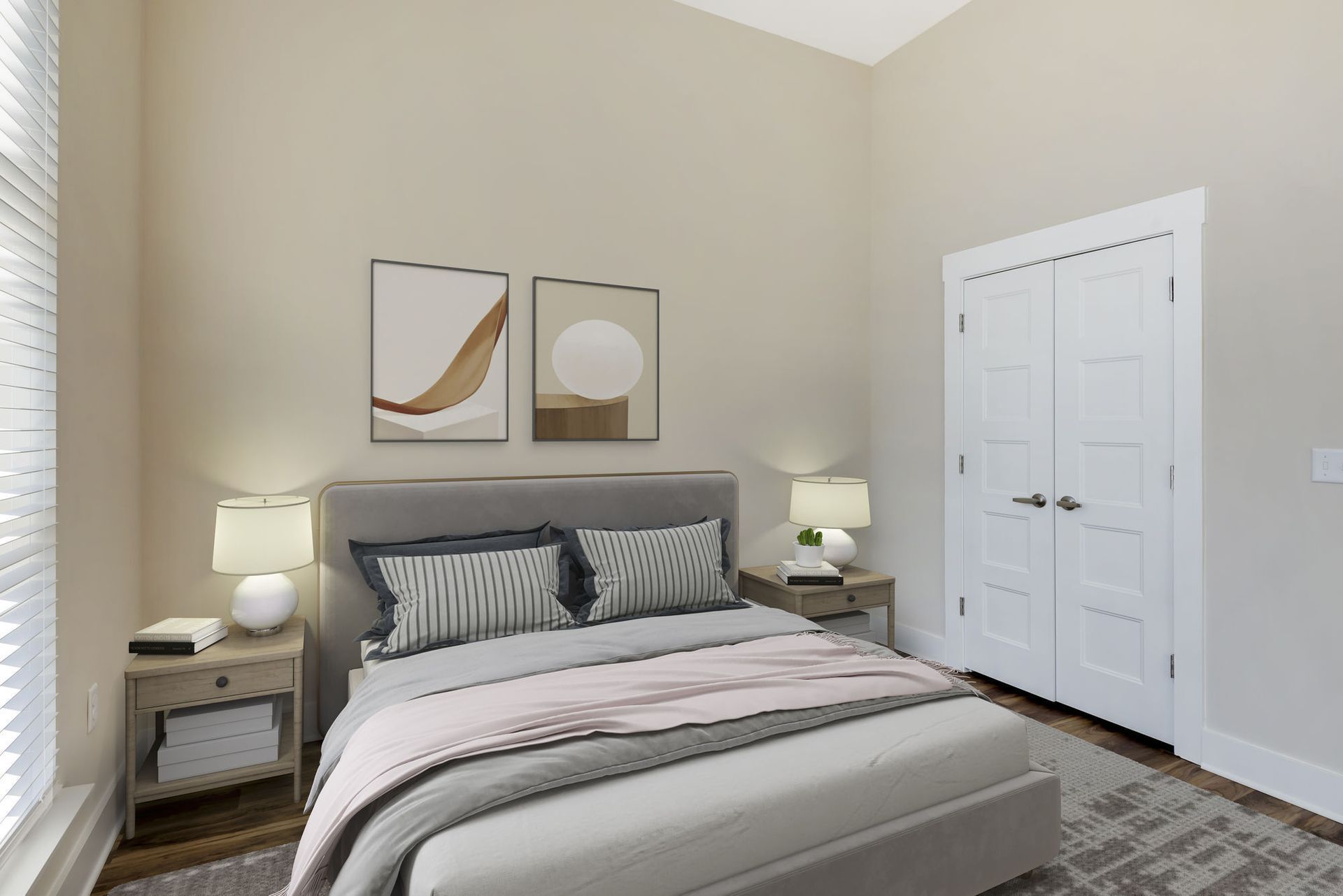Bedroom with a bed, two nightstands with lamps, artwork, and a white double door closet.