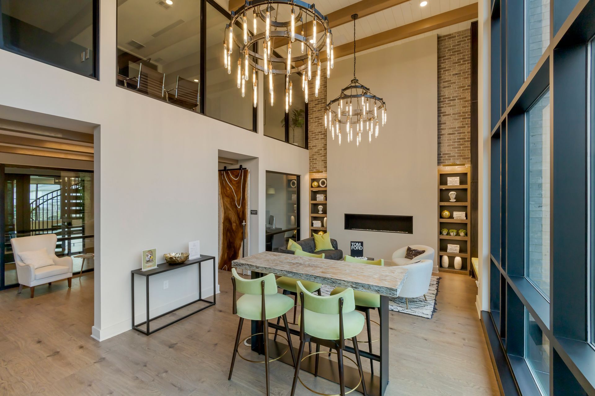 Spacious, modern living room with high ceilings, bar seating, and a fireplace.