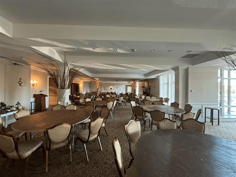 A man is standing on a ladder painting a wall.