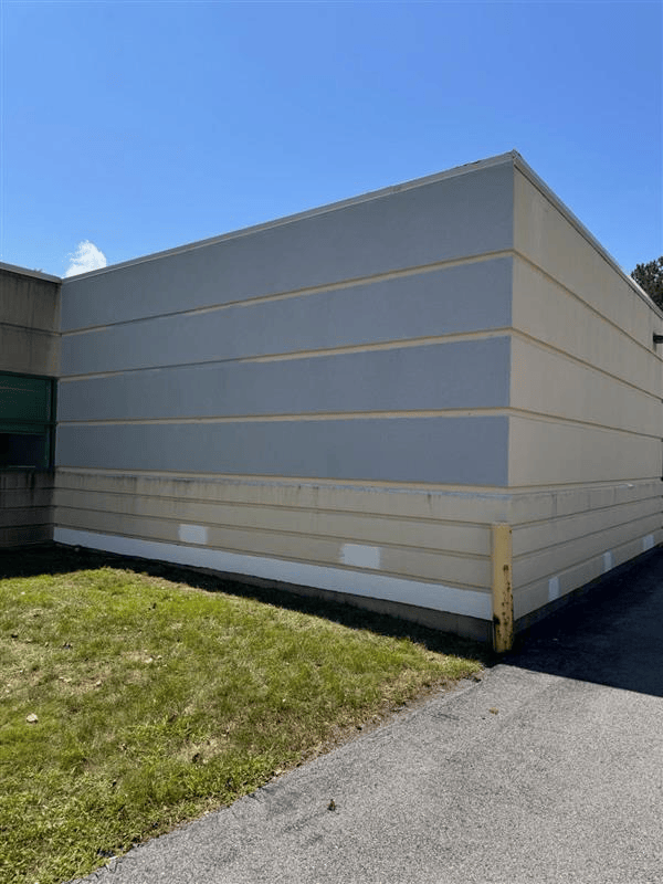 A person is plastering a wall with a spatula.