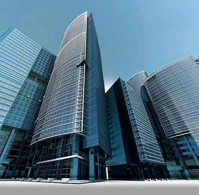 Modern glass office skyscrapers with curved facades against a blue sky
