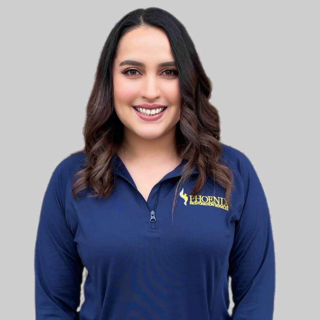 A woman wearing a blue shirt with the word phoenix on it