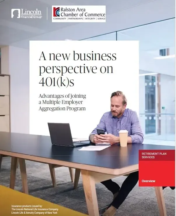 A man is sitting at a table with a laptop on it.
