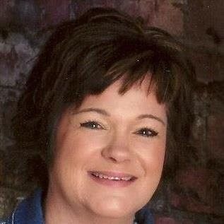 A man is taking a selfie with a bridge in the background.