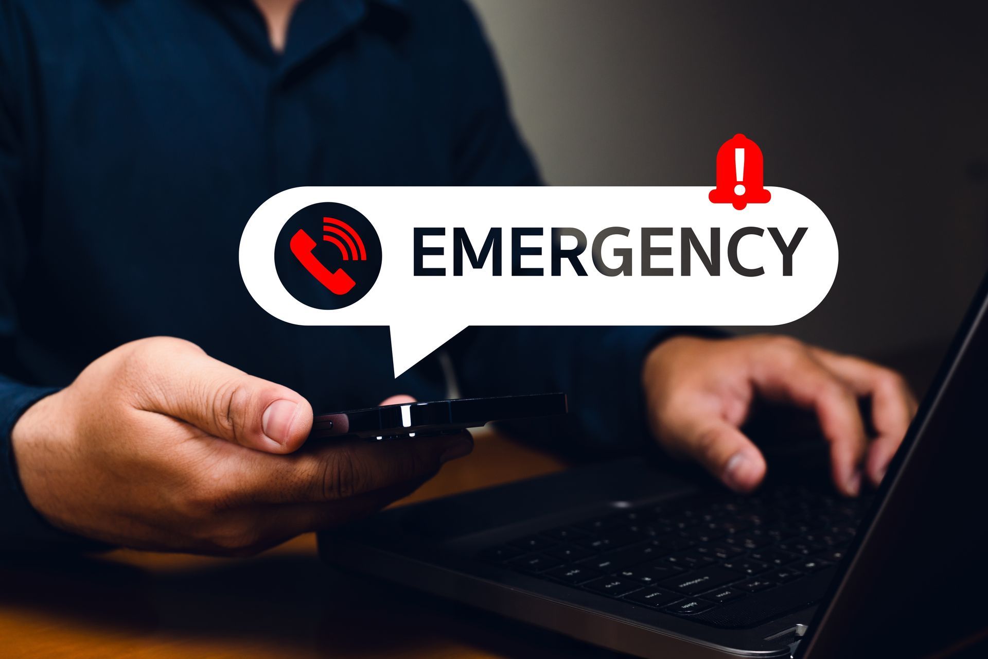 Person holding phone, emergency call notification displayed over their hands and laptop.