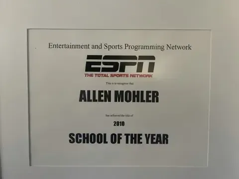A framed certificate that says entertainment and sports programming network allen mohler school of the year