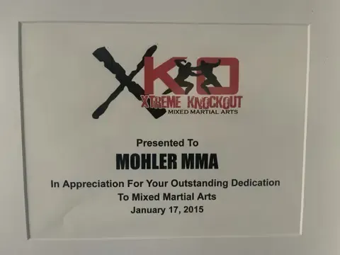 A plaque presented to mohler mma in appreciation for your outstanding dedication to mixed martial arts