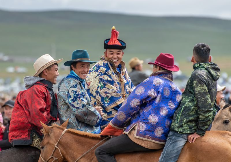 A group of people are riding on the back of a horse.