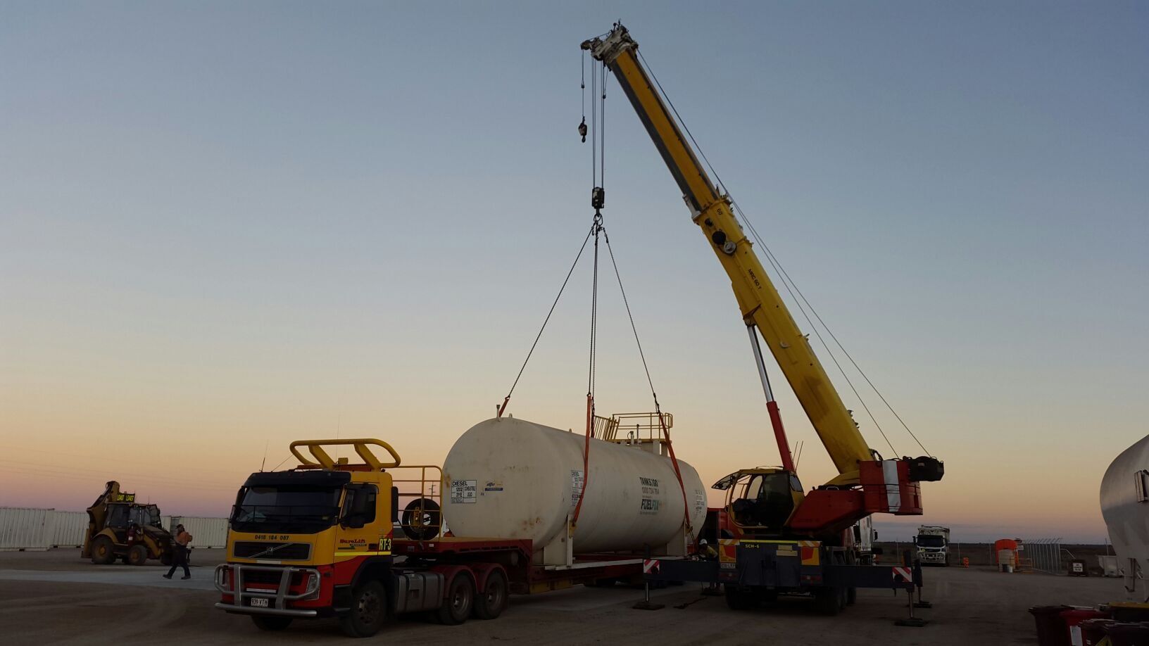 Crane Lifting A White Tank — Crane Hire & Transport in Moranbah, QLD