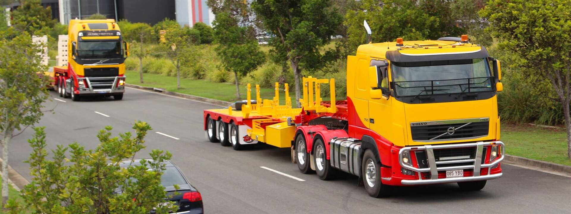 Two Crane Trucks On A Highway — Crane Hire & Transport in Moranbah, QLD