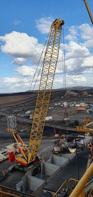 Crane Truck Lifting Heavy Equipment — Crane Hire & Transport in Moranbah, QLD