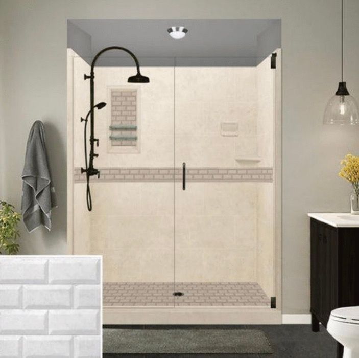 A modern bathroom with a beige shower, black fixtures, and white subway tile sample.