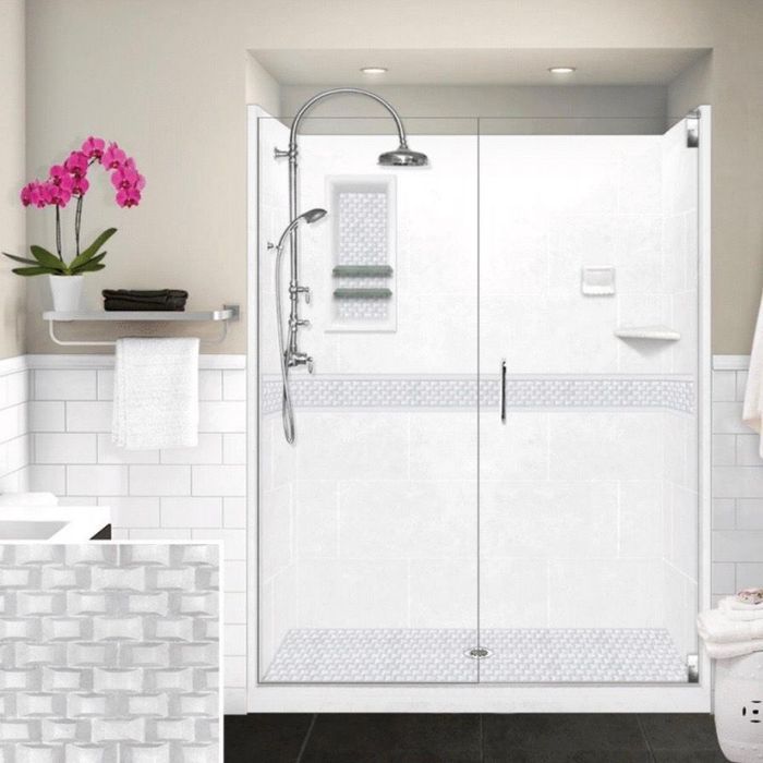 White bathroom with a shower, pink orchid, and gray accent tiles.
