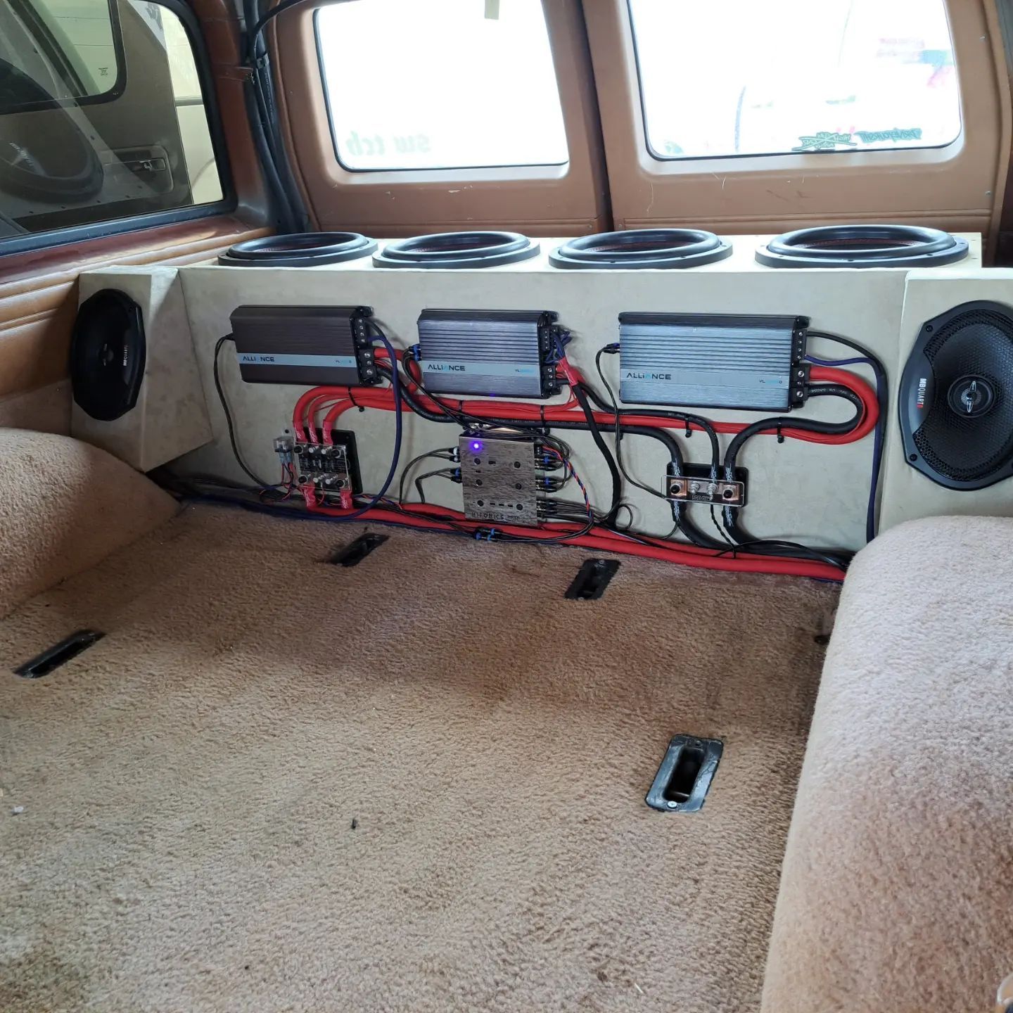White pickup truck with open hood, under a shelter. Chrome wheels, red license plate.