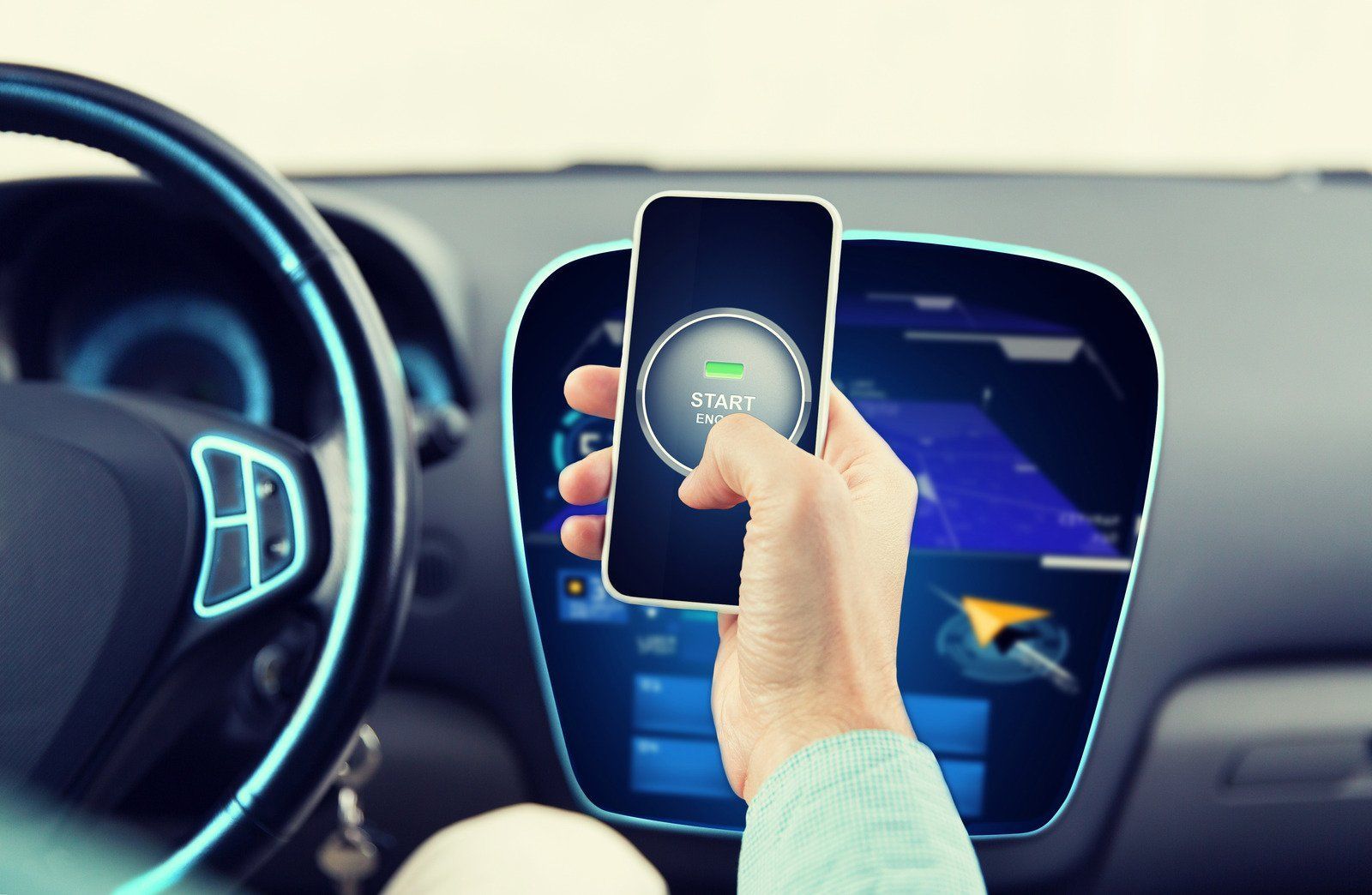 A person inside a car uses a phone, likely charging it. Dashboard with blue screen and steering wheel visible.