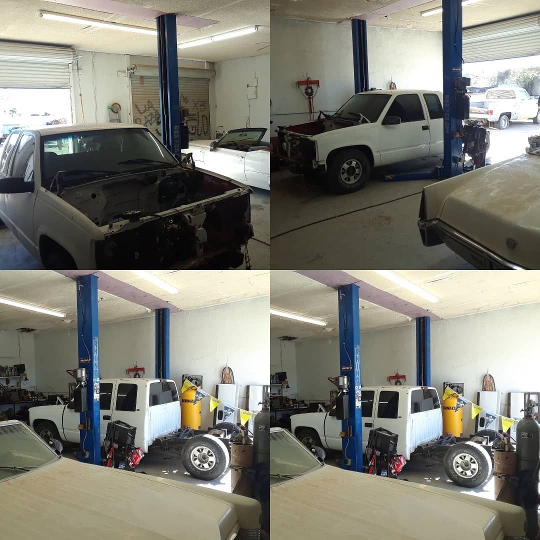 Four views inside a car repair shop showing white trucks on lifts, some disassembled, with equipment and open garage doors.