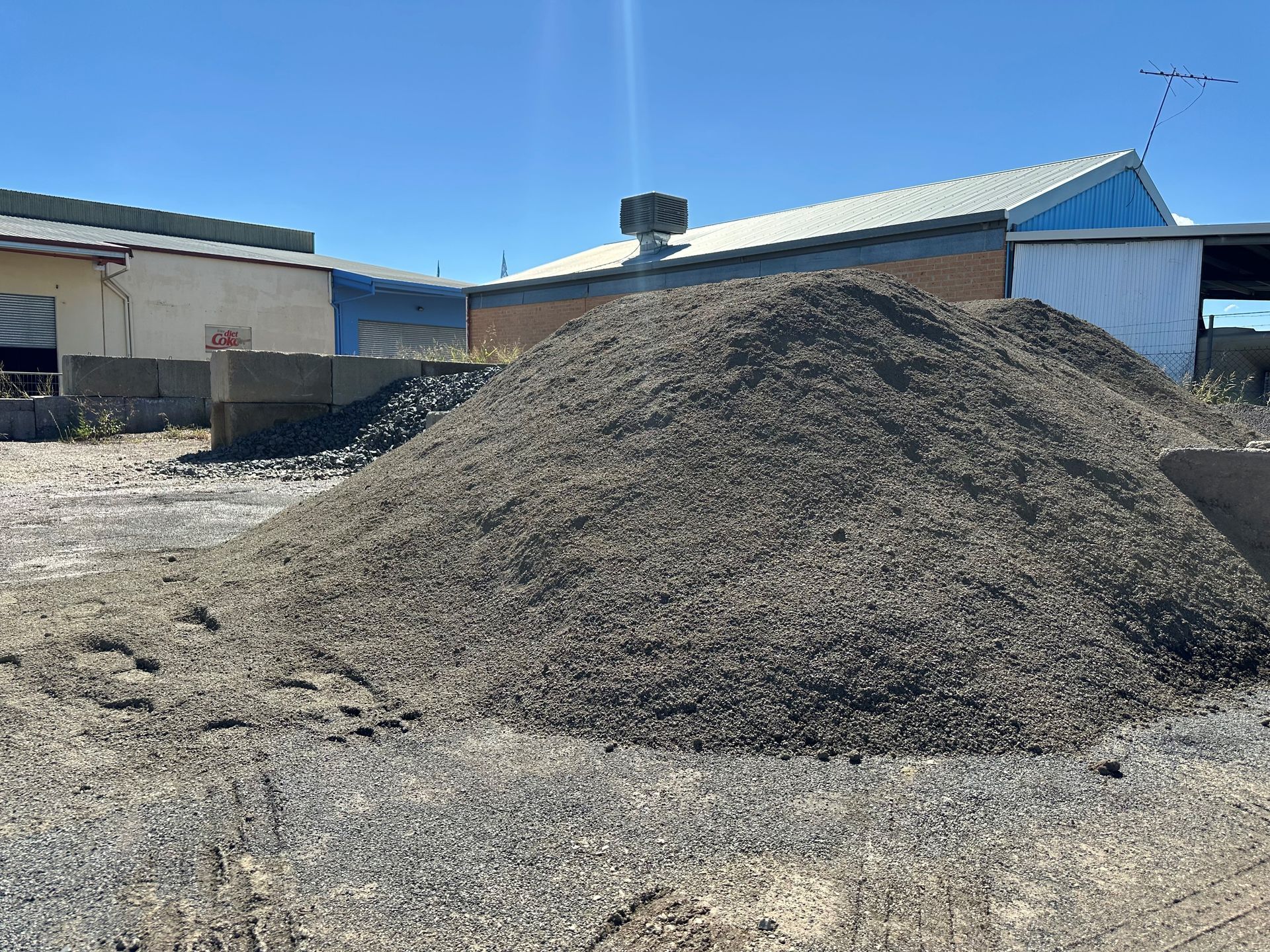 A Pile of Dirt is Sitting in the Middle of a Dirt Field — Dampier Street Landscape Supplies in Taminda, NSW