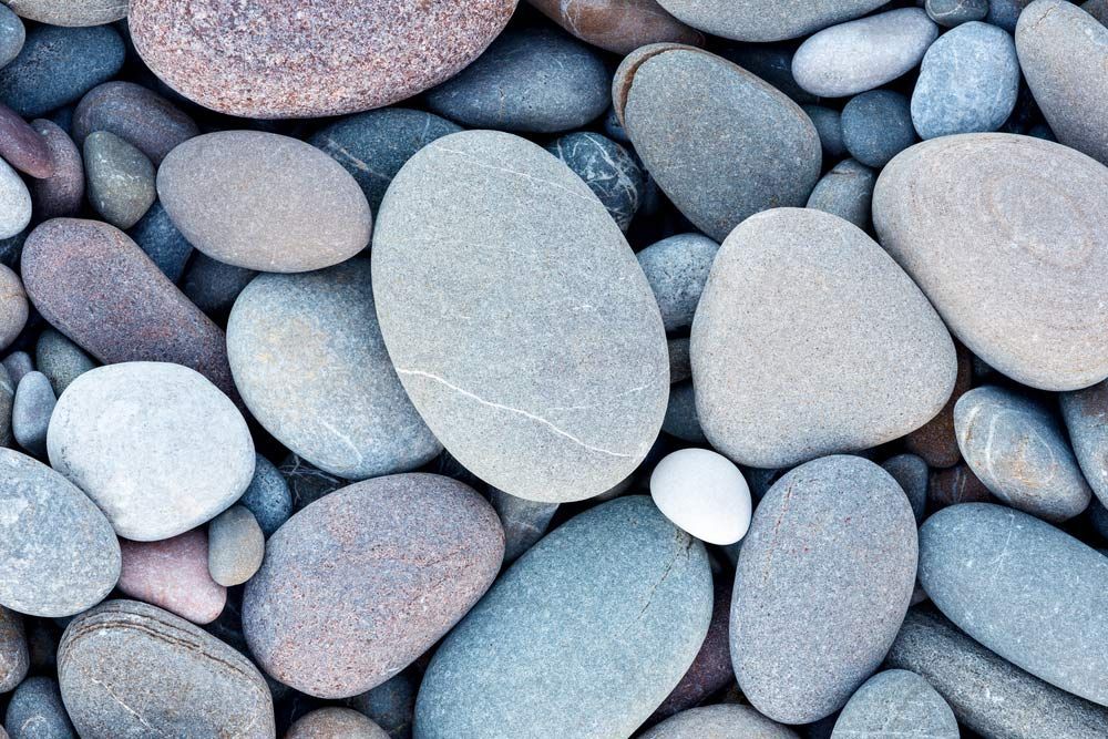 A Pile of Rocks With a White Rock in the Middle — Dampier Street Landscape Supplies in Taminda, NSW