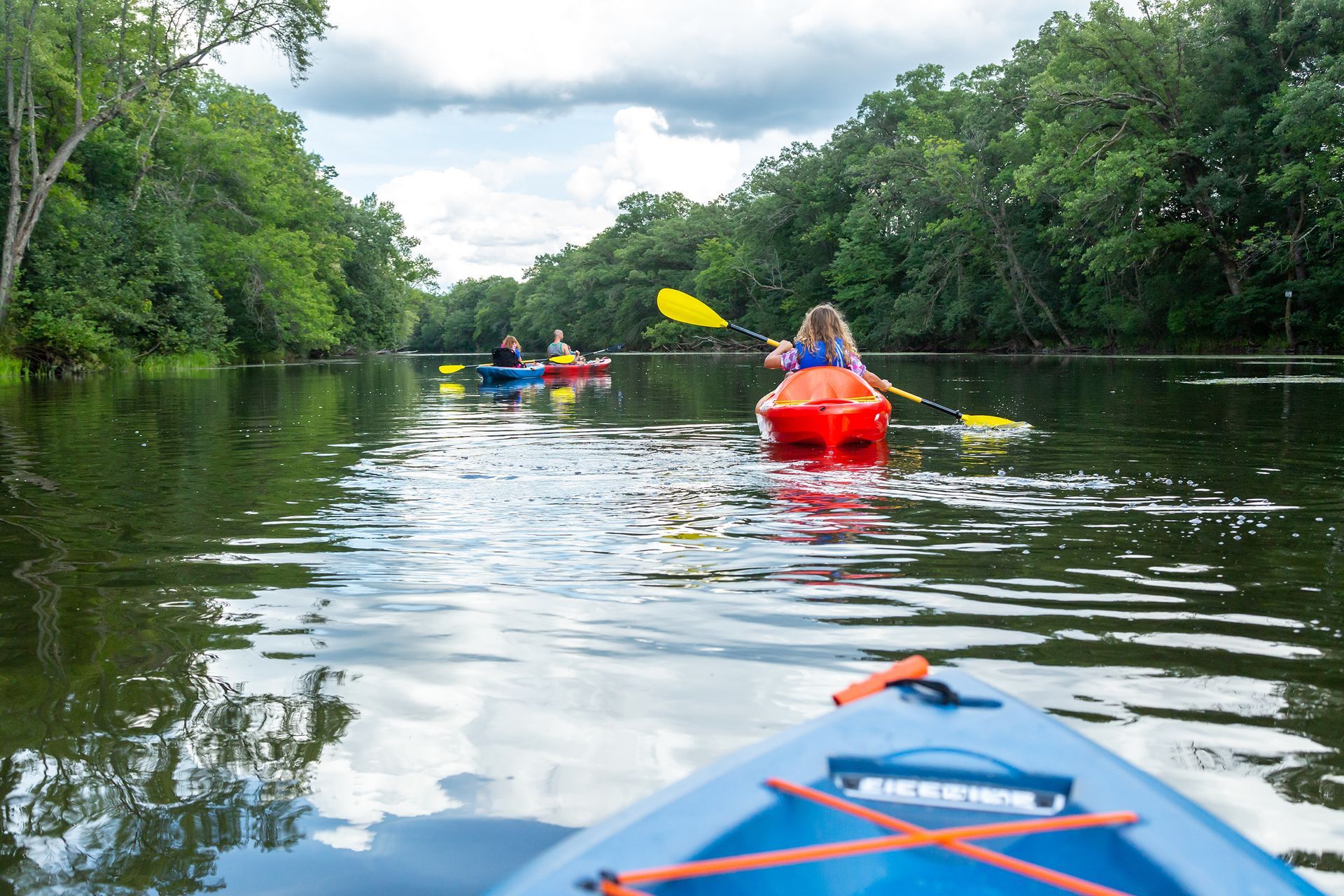 A group of people are kayaking down a river.
