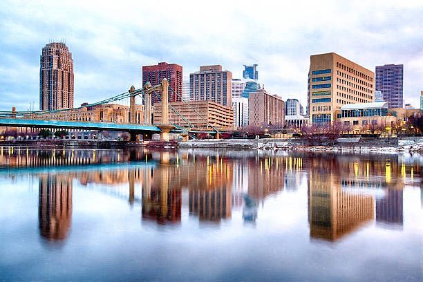 A city skyline is reflected in a body of water.