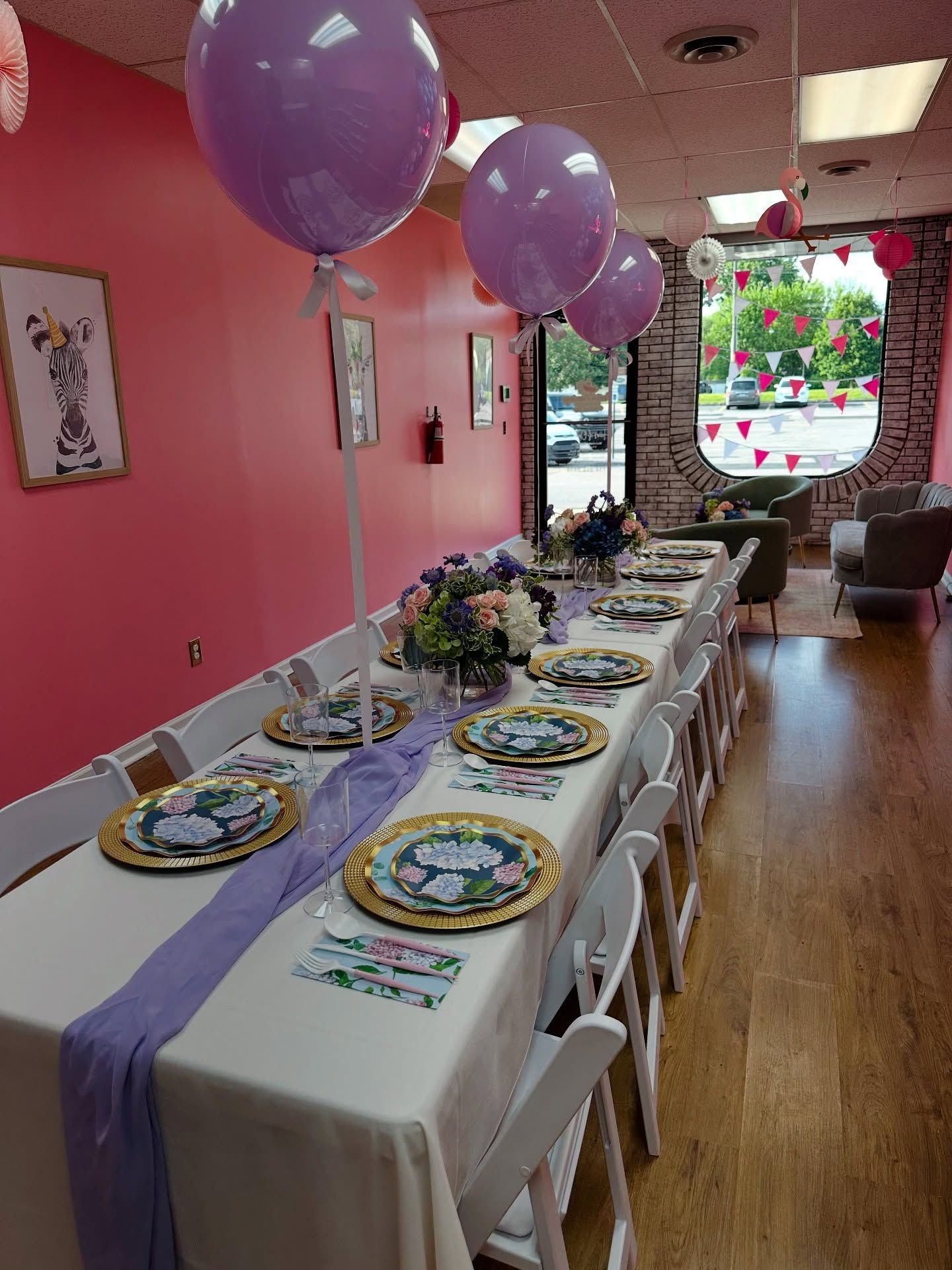 A long table with plates and balloons on it