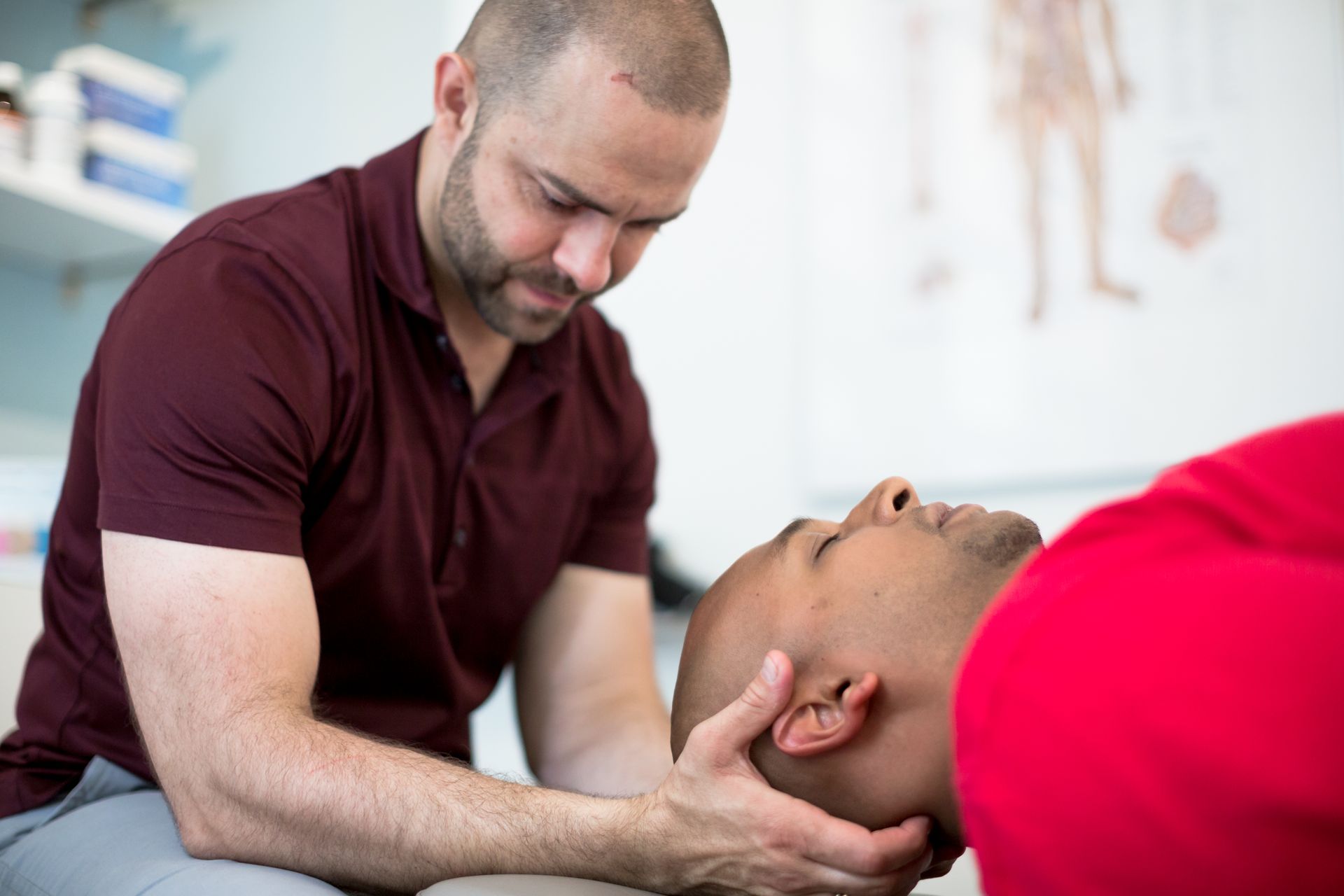 A man is giving a man a neck massage.