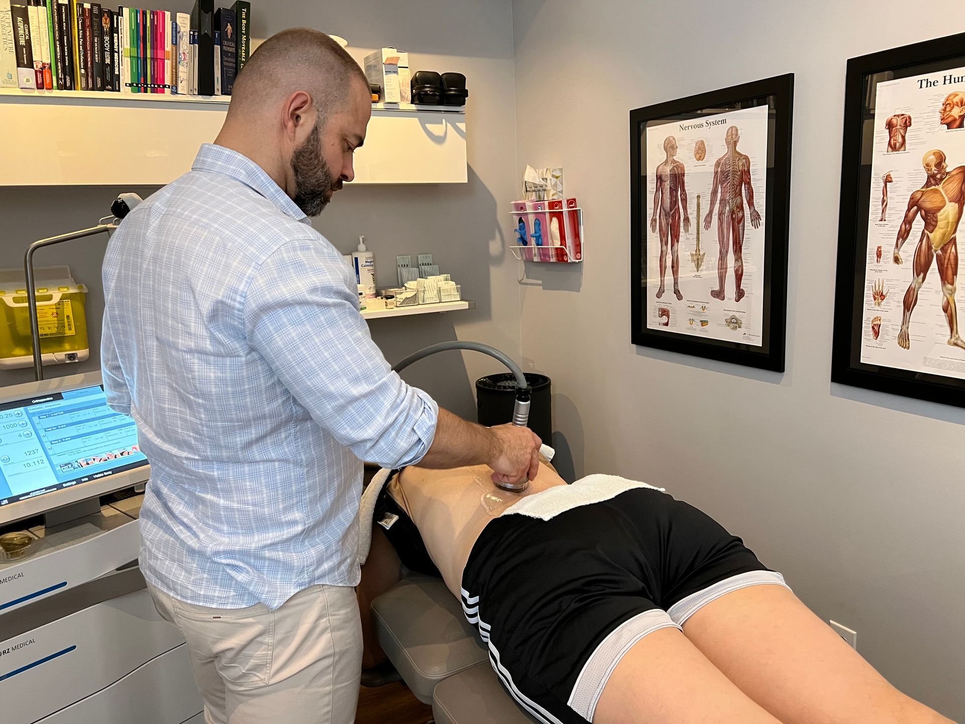 A man is giving a woman a massage in a room.