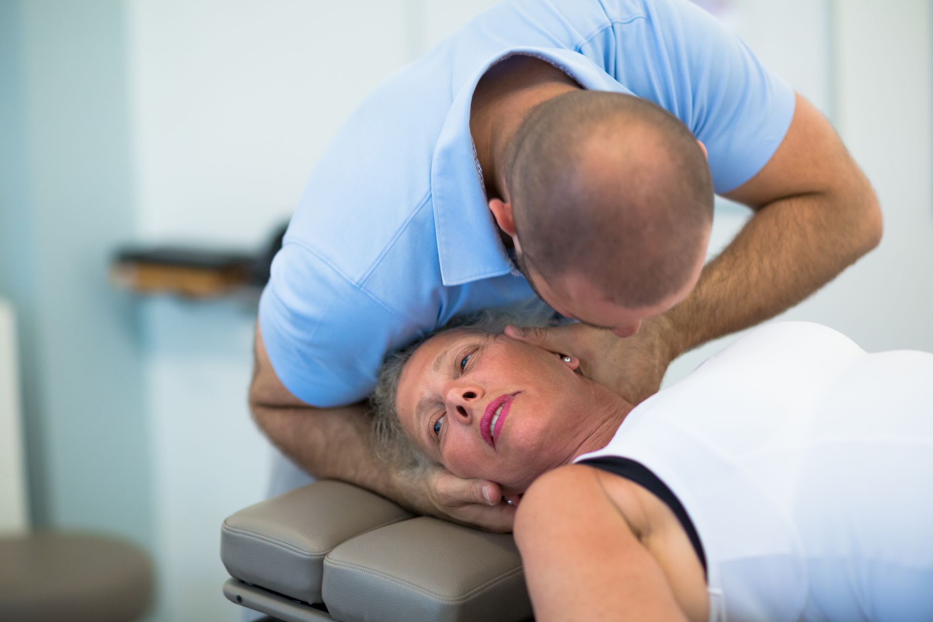 A man is giving a woman a massage on her back