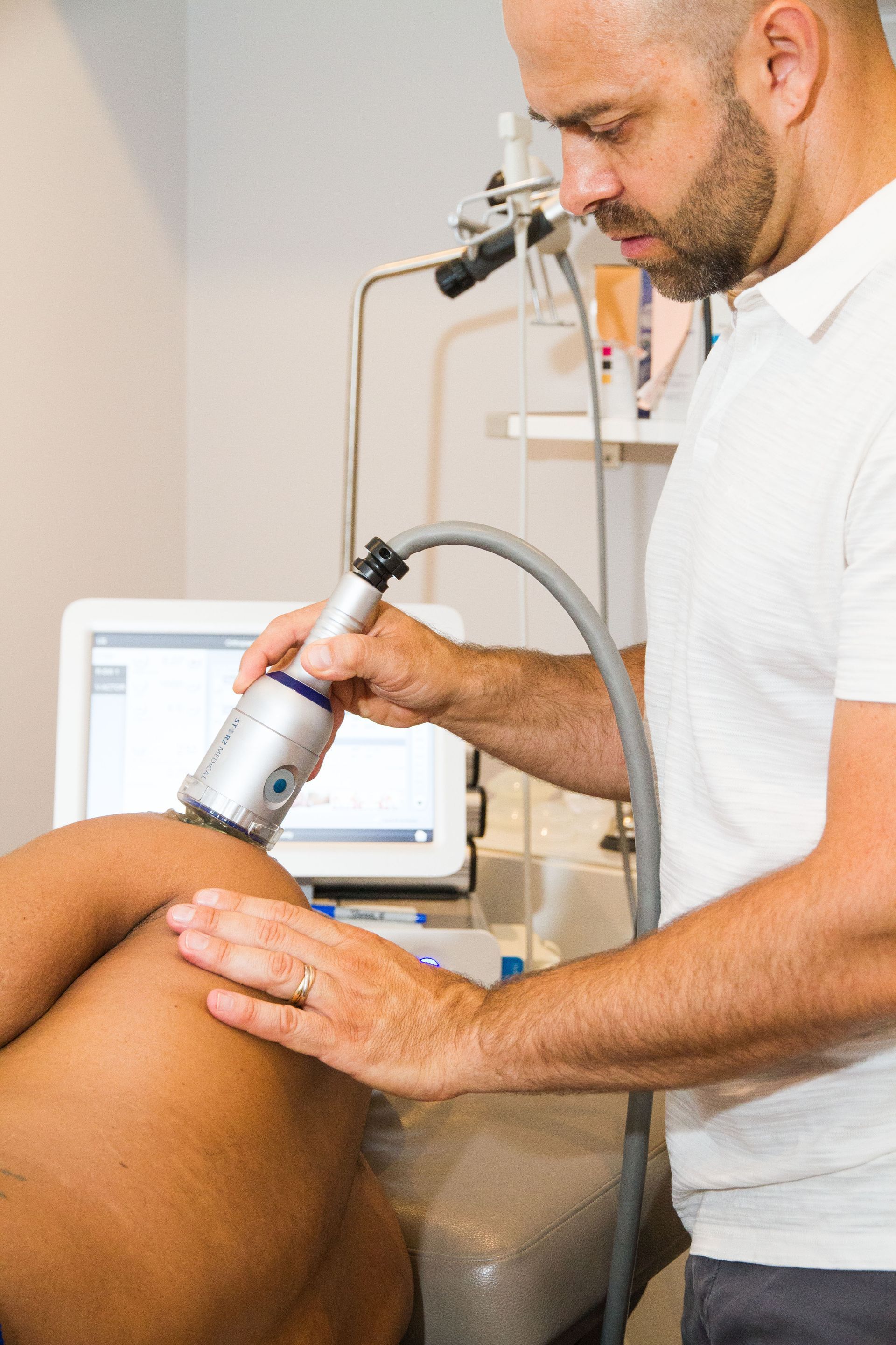 A person is using a device on a child 's foot.