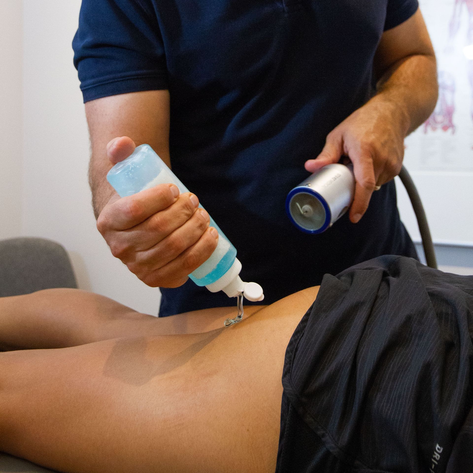 A woman is getting a knee treatment with a machine.