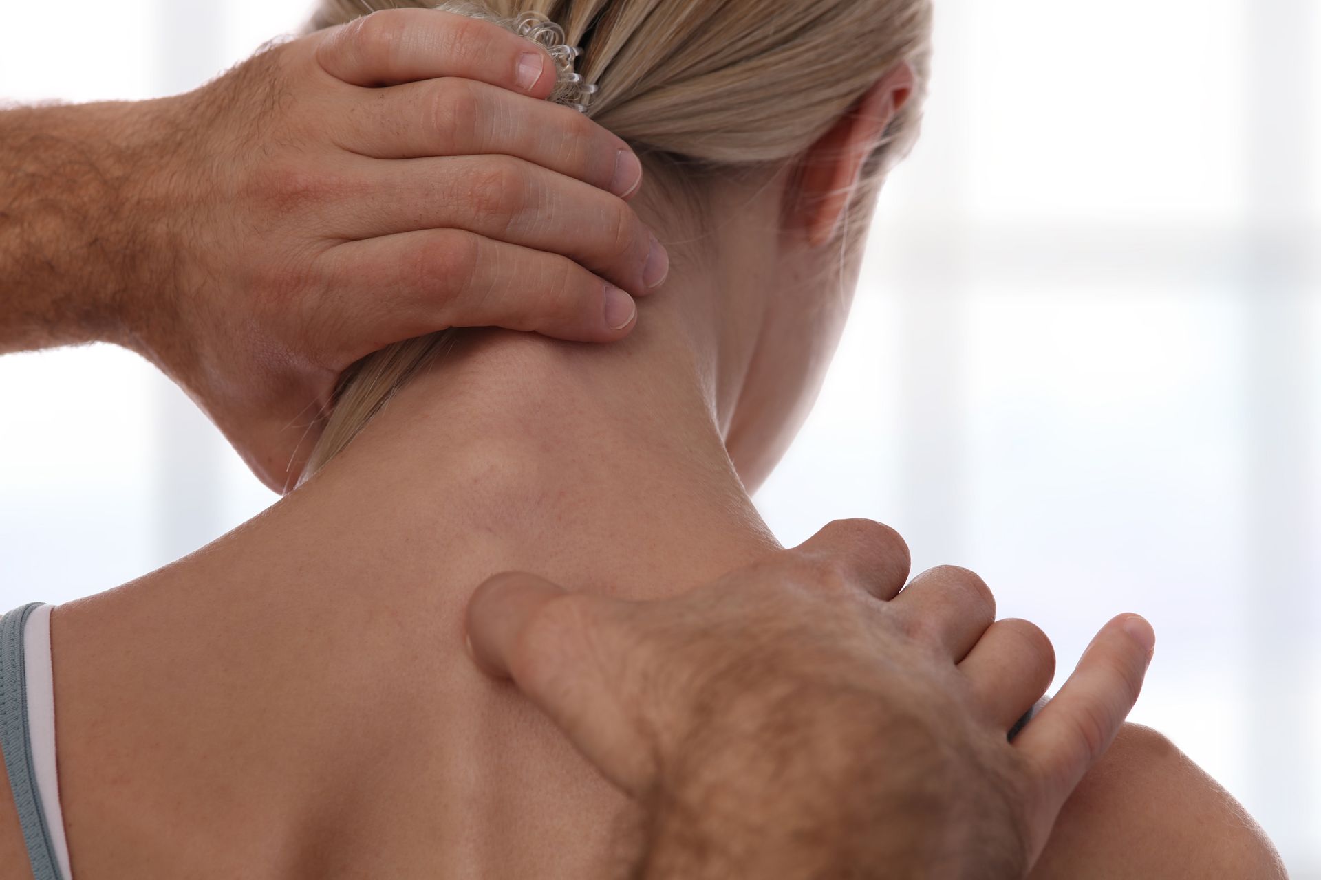 A man is giving a woman a neck massage.