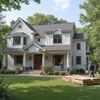 Two-story white house with dark trim and roof. Two men working on the exterior on a sunny day.