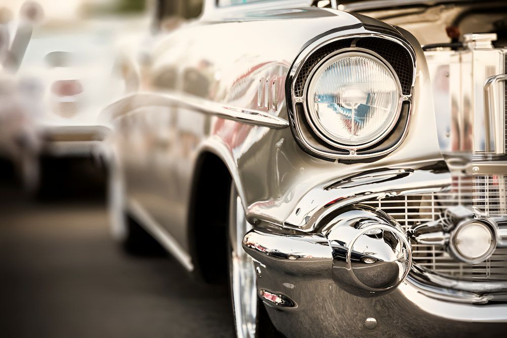 A Classic Car With The Hood Up Is Parked On The Street — 100% Automotive In South Nowra, NSW