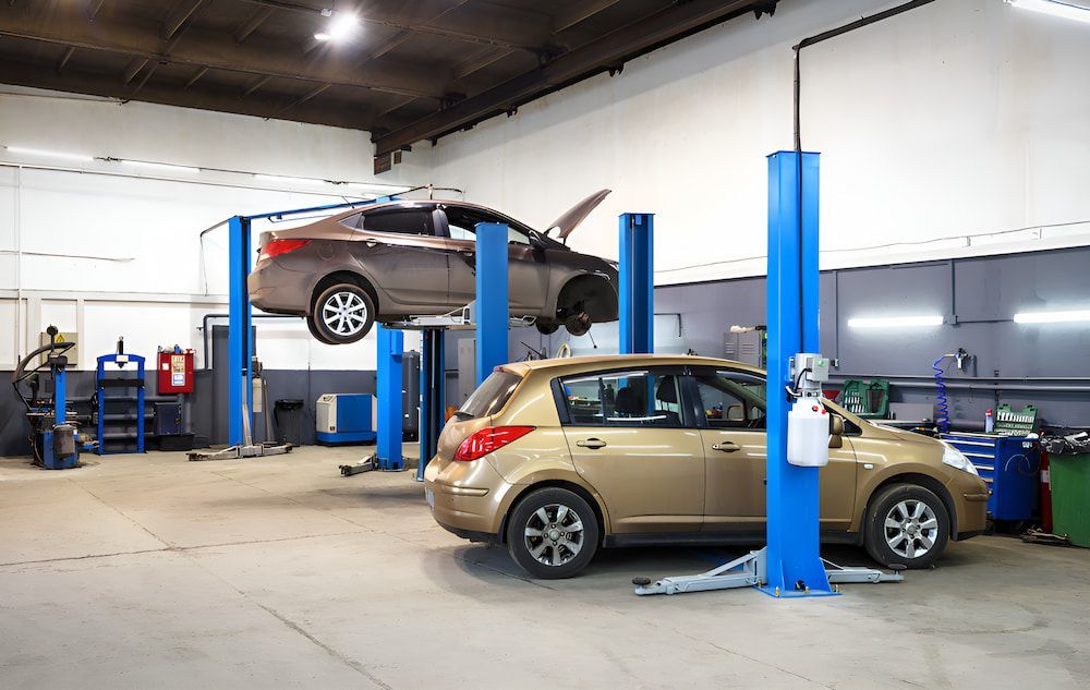 A Car Is Sitting On A Lift In A Garage β 100% Automotive In South Nowra, NSW