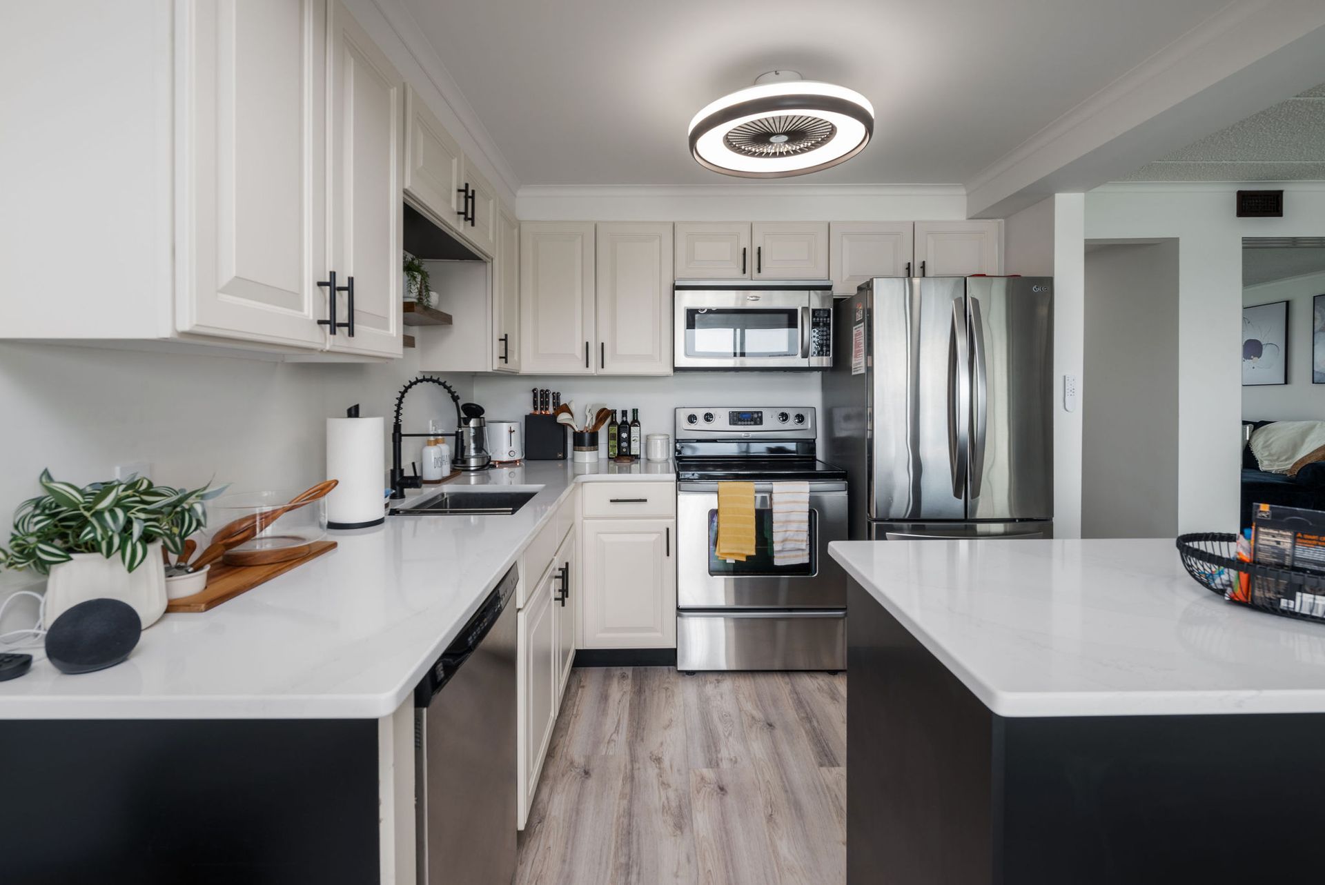 A kitchen with white cabinets and stainless steel appliances.