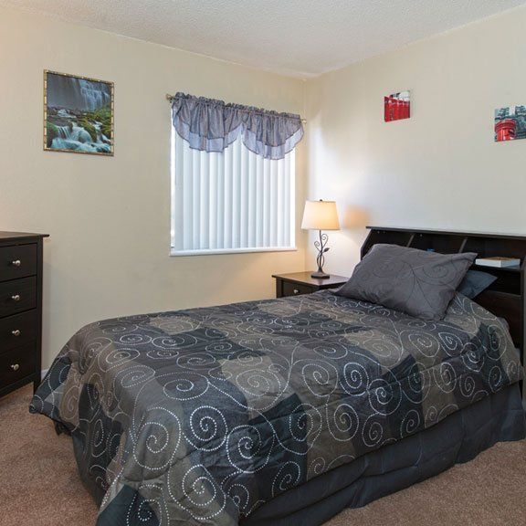 Furnished bedroom with a window