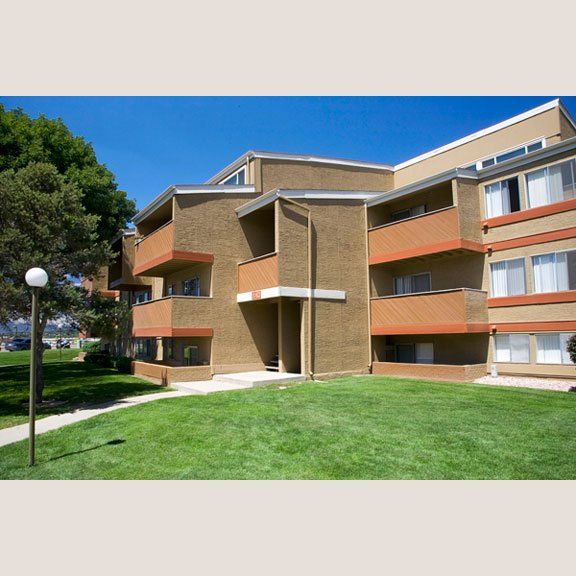 Apartment building with green grass outside