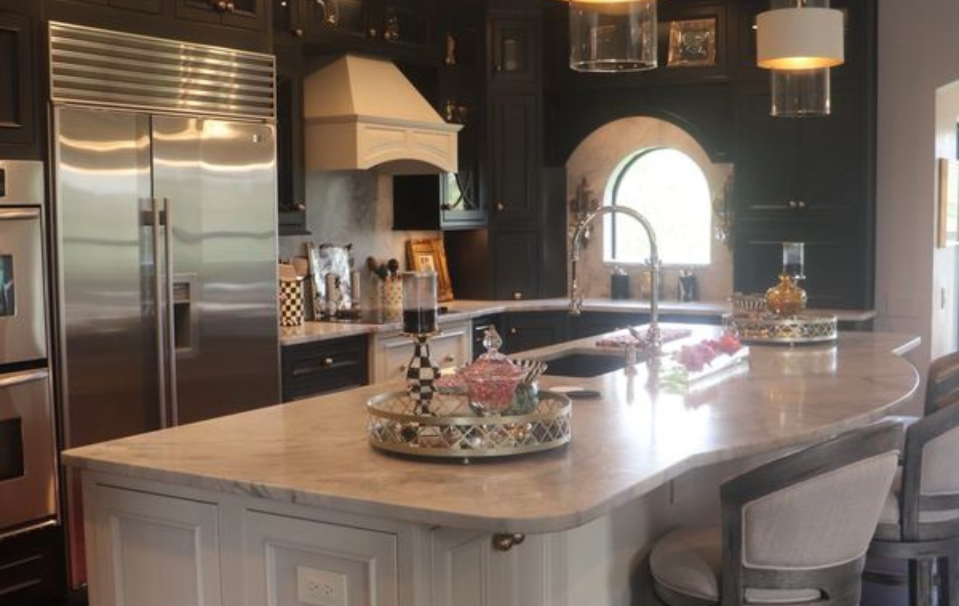 A kitchen with stainless steel appliances and a large island.