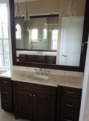 A bathroom with two sinks and a large mirror.
