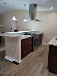 A kitchen with stainless steel appliances and wooden cabinets.