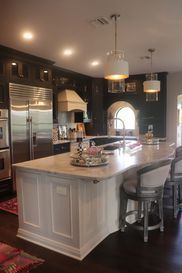 A kitchen with a large island in the middle of it.